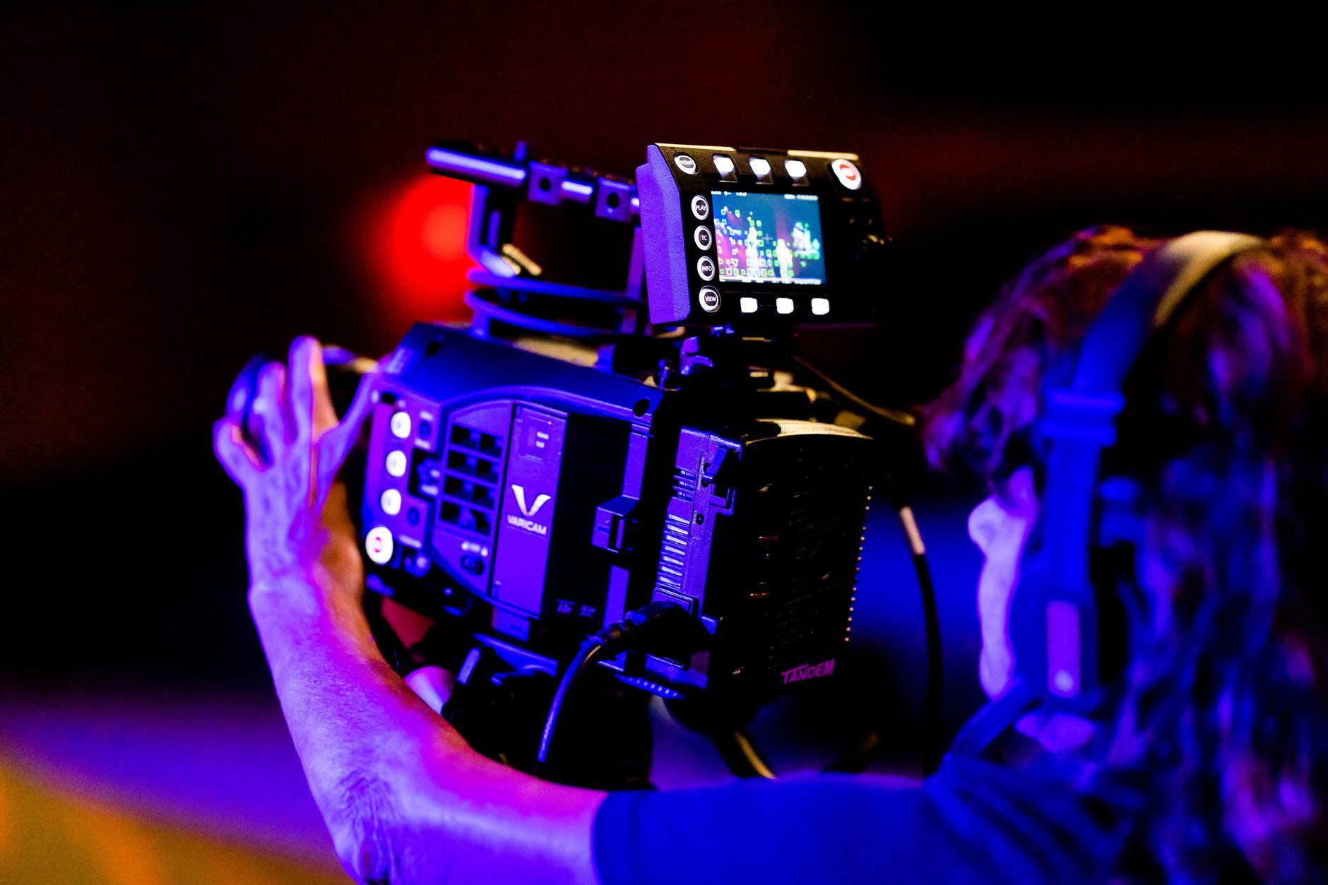 TV Production team working behind high-end switcher desk panel